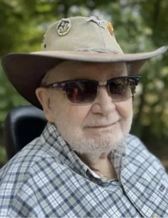 Elderly man in hat and sunglasses outdoors
