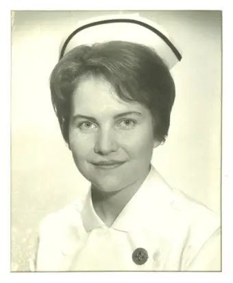 Vintage photograph of a smiling nurse in uniform.