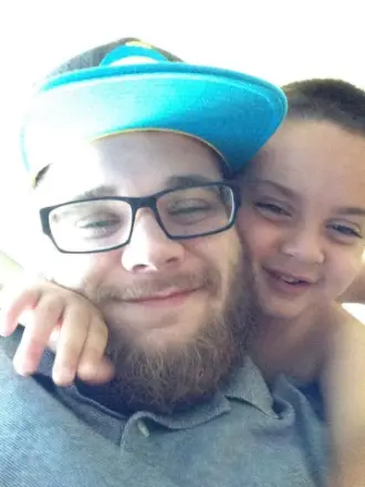 Smiling man with glasses and child having fun