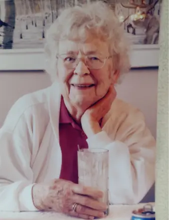 SCOTT, Marie Helen Scott Elderly woman smiling with a glass in hand.