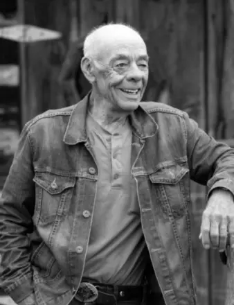 Smiling man in denim jacket, outdoors
