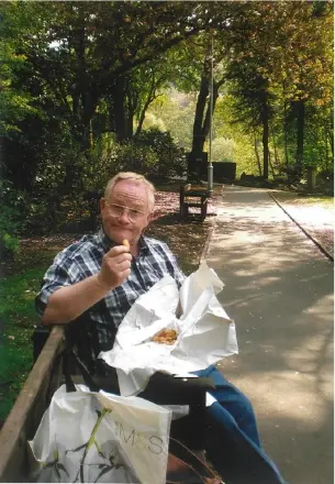 Man eating on park bench outdoors
