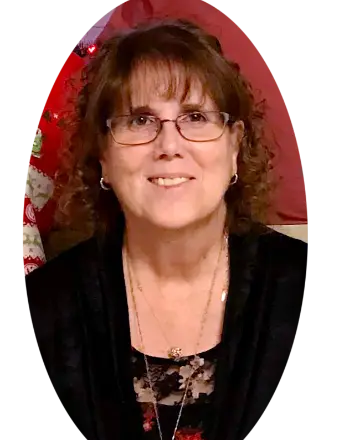 Woman smiling in glasses and black top