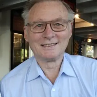 Smiling person wearing glasses indoors