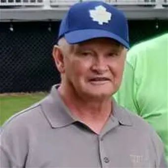 Man in blue cap and gray shirt outdoors
