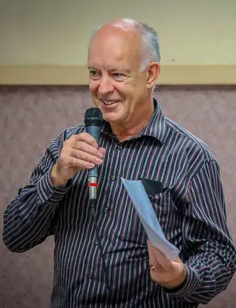 Smiling man speaking into microphone