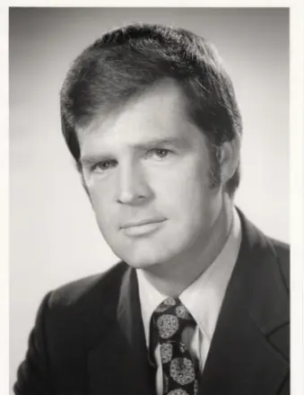 Black and white portrait of a man in suit.