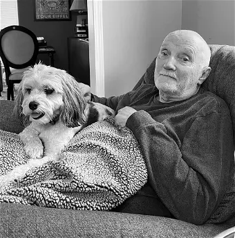 Man relaxing with dog on couch