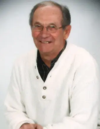 Smiling elderly man in white sweater