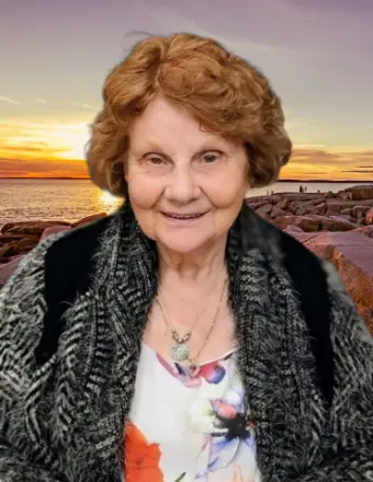 Elderly woman smiling with ocean sunset background