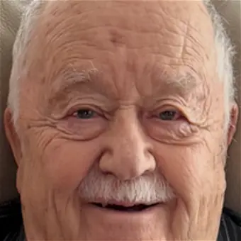 Elderly man smiling warmly at camera