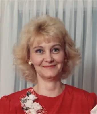 Woman smiling in red dress with flowers