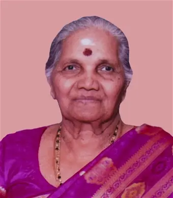 NADARAJAH, Sarojinidevi Nadarajah Elderly woman in traditional Indian attire, pink background.