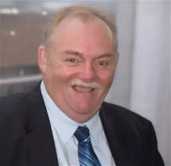 Smiling man in a suit indoors