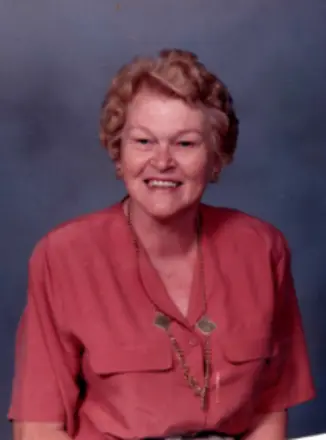 Smiling woman in pink blouse