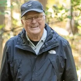 Smiling man in outdoor jacket and cap