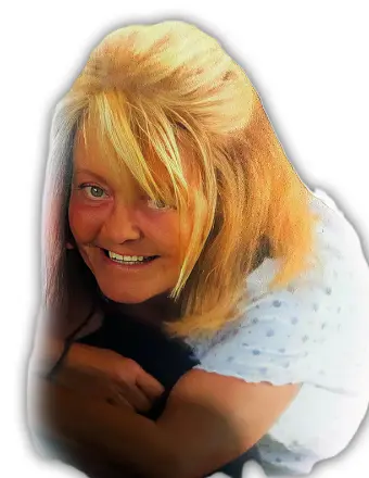 Woman in white smiling brightly at camera