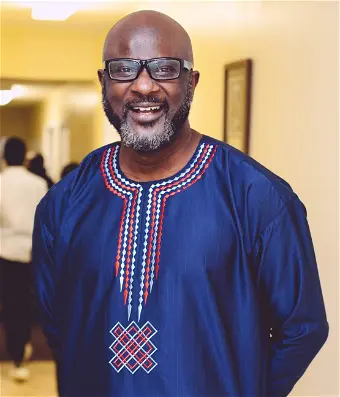 FAMBEGBE, Ayoola Fambegbe Smiling man in a blue traditional outfit