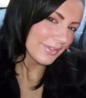 Person with dark hair smiling at camera