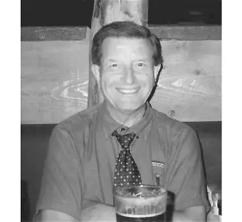 Smiling person sitting with a drink at table