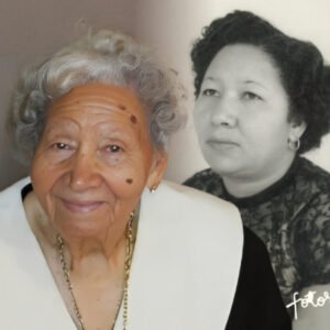 Older woman smiling with past portrait background.