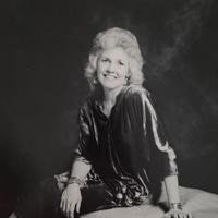 Smiling woman seated, vintage style portrait