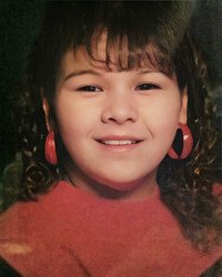 Smiling girl with hoop earrings and bangs