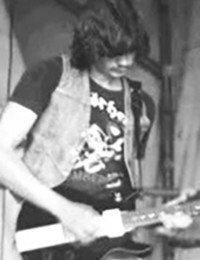 Musician playing electric guitar on stage