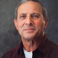 Portrait of a man with a neutral expression.