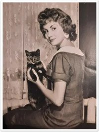 Woman holding cat in vintage photograph