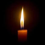 Glowing candle in the dark scene