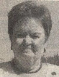 Portrait of a woman smiling outdoors.