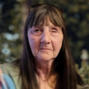 Older woman with long hair and bangs.