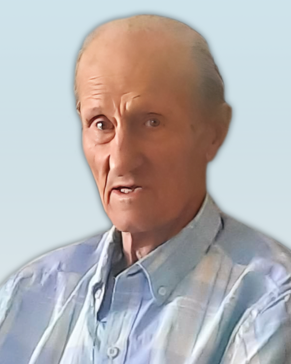 BOUDREAU, Victor Joseph Boudreau Elderly man in light plaid shirt, neutral background.