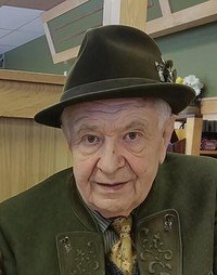 Elderly man in green hat and coat
