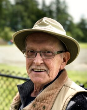 Smiling man wearing a hat outdoors