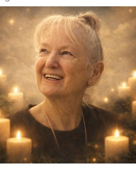 Smiling woman surrounded by glowing candles.