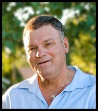 Smiling man outdoors with blurred background