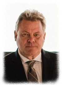 Portrait of a man in a suit and tie.