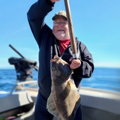 YAGER, Jerome Yager Man proudly holding a large fish on a boat.