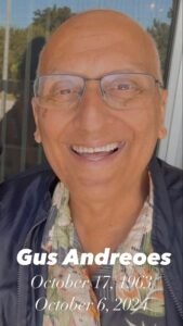Smiling man with glasses and date inscriptions.