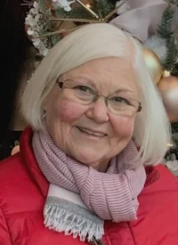 Smiling woman with glasses and winter coat
