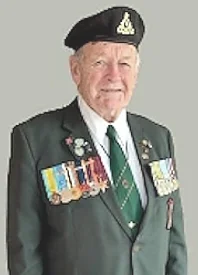 Elderly veteran wearing uniform with medals.