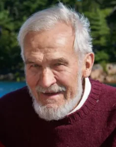 Elderly man with gray beard outdoors in nature