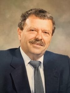 Smiling man in suit and tie portrait.