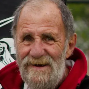 Smiling elderly man with gray beard outdoors