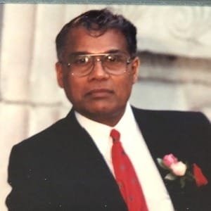 Man in suit with red tie and rose boutonniere