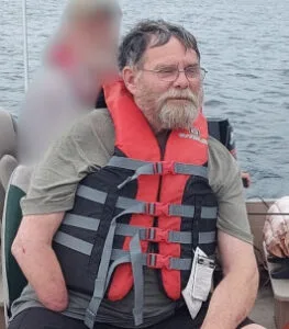 Man wearing a life jacket on a boat.