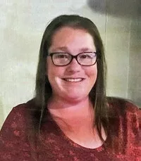 Smiling woman wearing glasses and a red shirt.