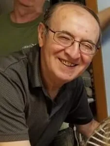 Smiling man with glasses indoors